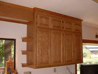 Red oak upper cabinet and light box with arched raised panel doors